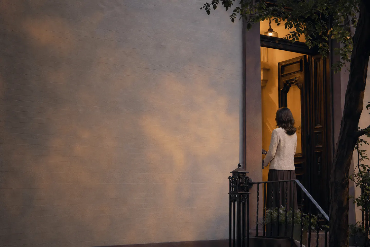 A warm brownstone doorway with soft light spilling onto the stoop